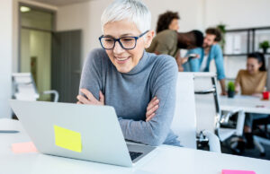 Mature woman looking at a computer in an office