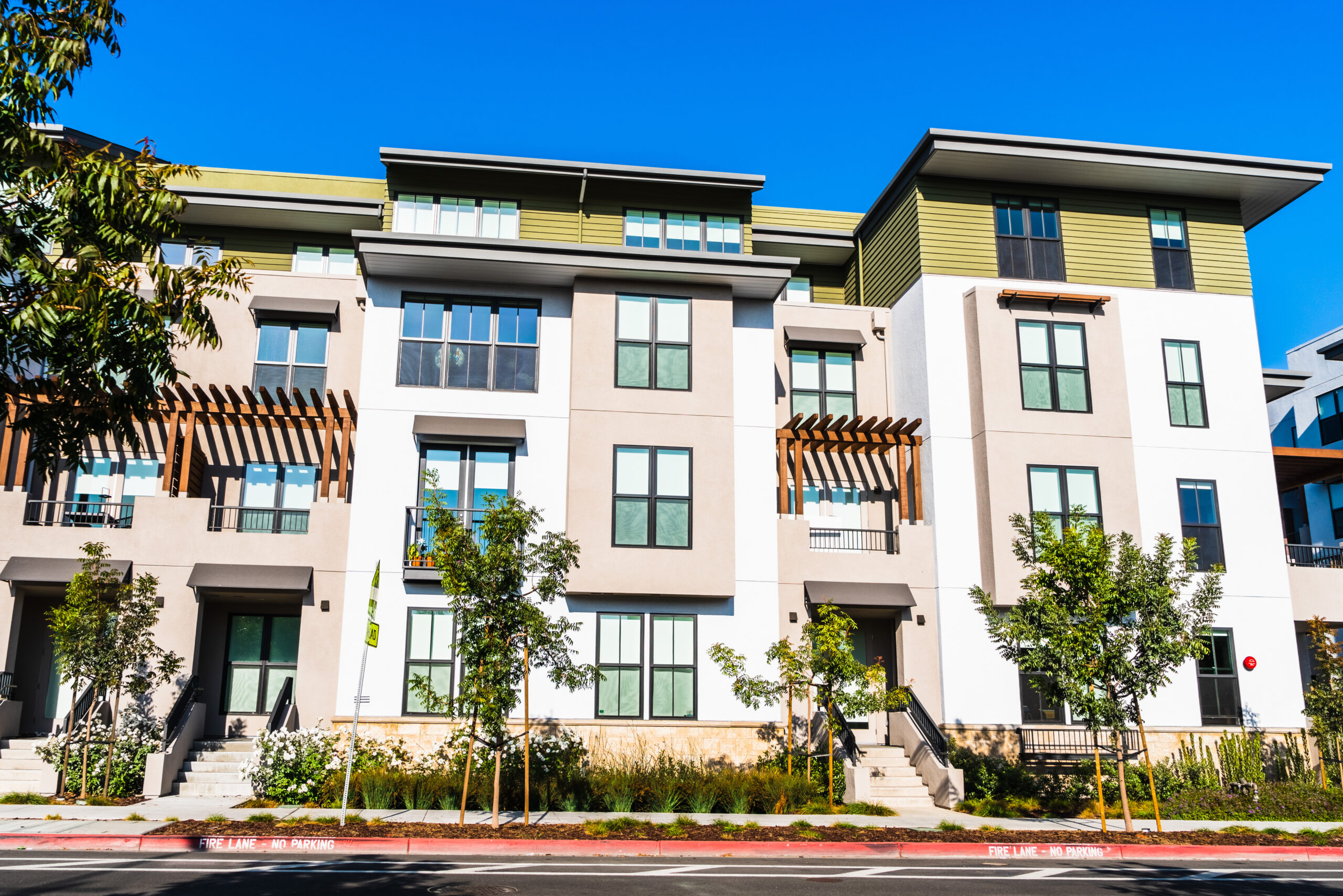 Attractive affordable housing apartment building. Exterior view. Blue sky!