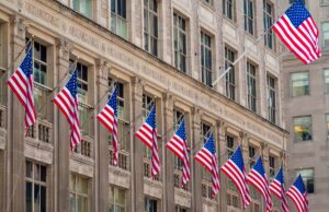 Large government building with row of American flags.