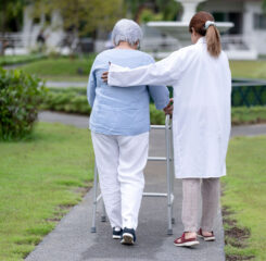 care center staff assisting elderly resident 1200 776