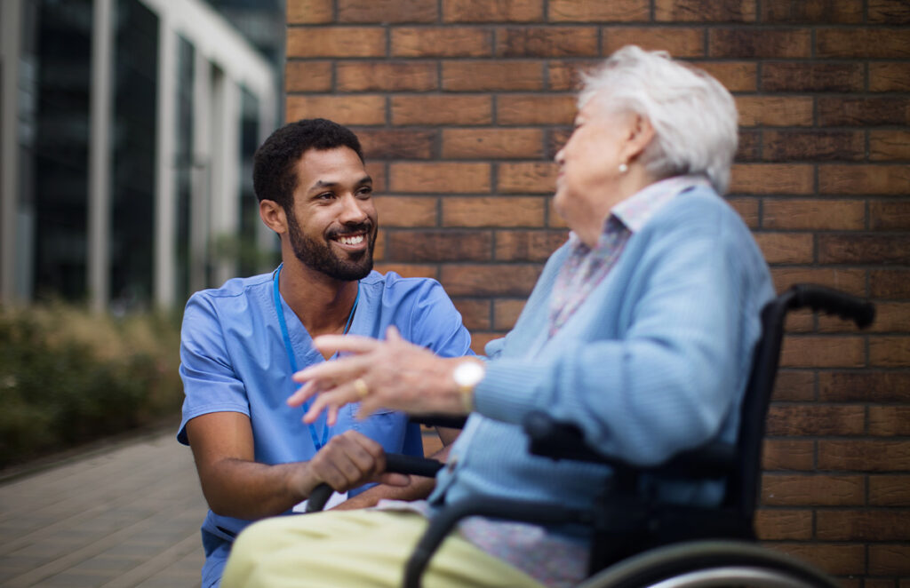 caretaker assisting elderly woman outdoors 1440953730 1200 776