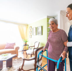 caretaker assisting elderly woman walking 1459390875 1200 776