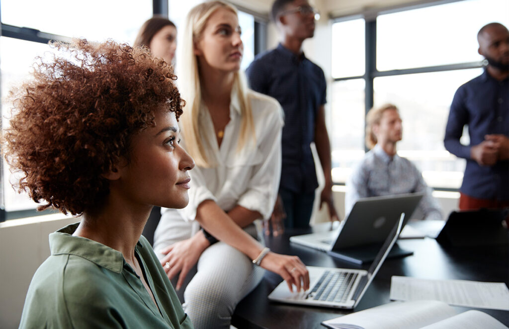 diverse professionals watching speaker in meeting 1146472969 1200 776