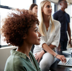diverse professionals watching speaker in meeting 1146472969 1200 776