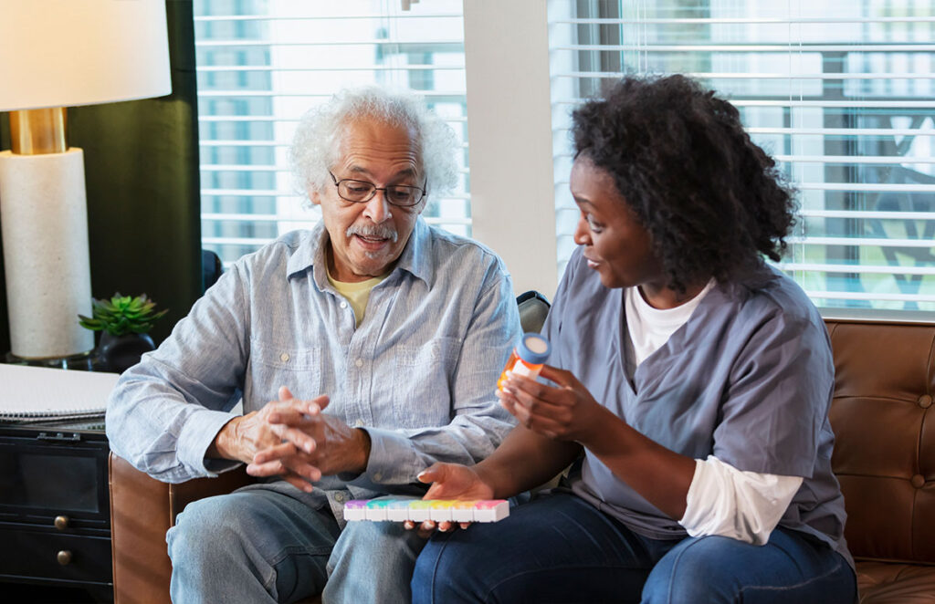 elderly man and caretaker discussing medications 1397411369 1200 776