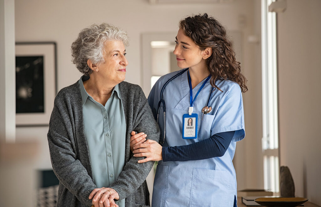 elderly woman assisted by caretaker 1296176562 1200 776