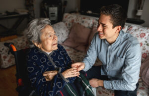 elderly woman in wheelchair with family caretaker 1299907356 1200 776