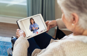 elderly woman speaking with doctor on tablet 1316204932 1200 776