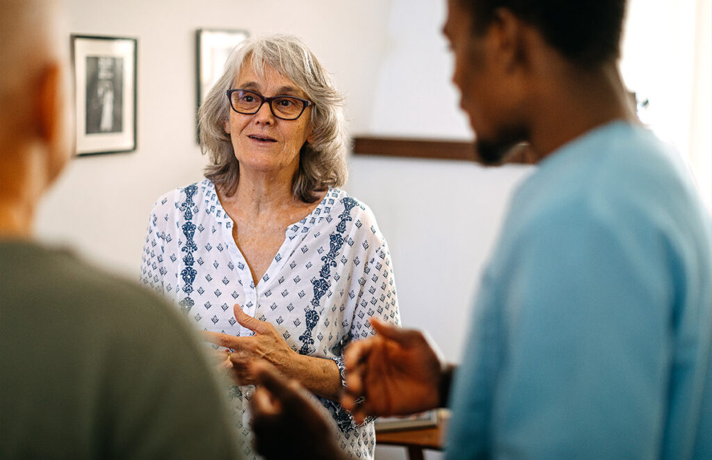 elderly woman speaking with medical staff 1202682496 1200 776