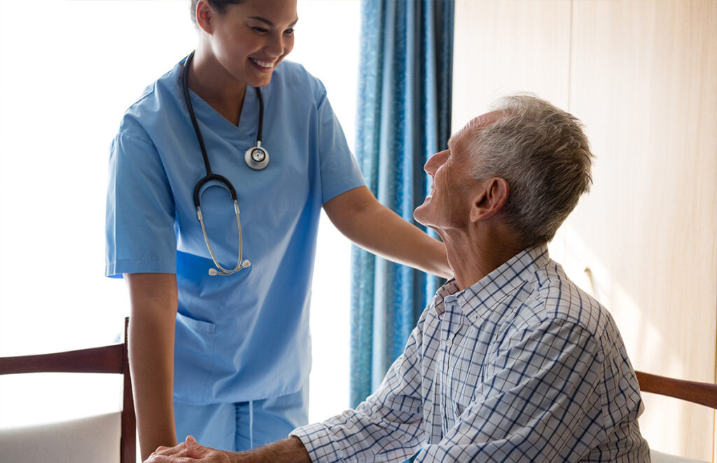 healthcare worker speaking with senior patient 1200 776