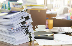 hospital office with stack of files and pen 621505910 1200 776