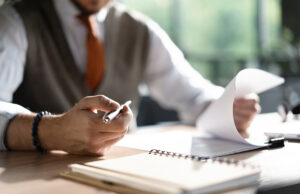 man at desk reviewing files 1473547309 1200 776