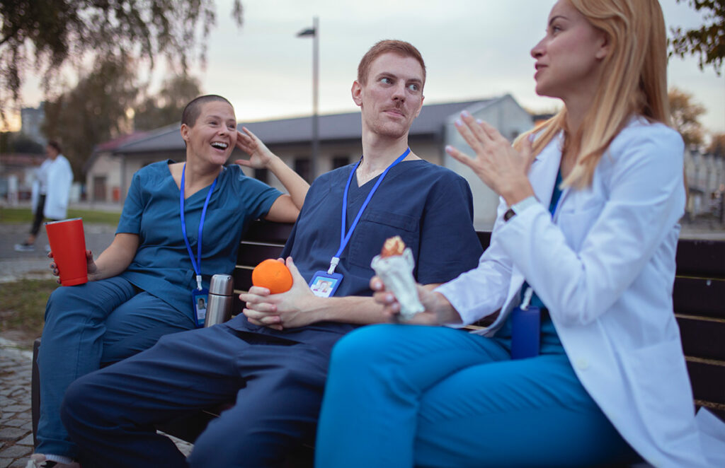 medical staff talking smiling on outdoor bench 1446502648 1200 776