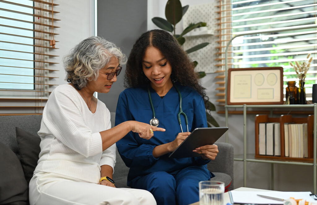 nurse speaking with senior woman 1200 776