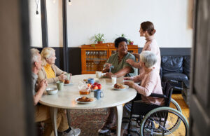 nursing home worker serving residents 1200 776