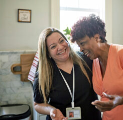 senior woman laughing with caretaker in assisted living center 1406942073 1200 776