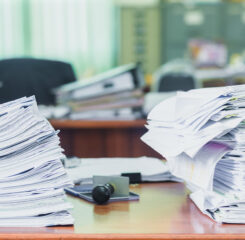 two stacks of files on desk 1161940000 1200 776