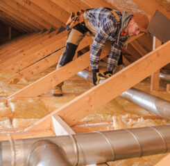 worker building affordable housing in roof 1200 776