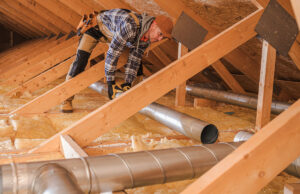 worker building affordable housing in roof 1200 776