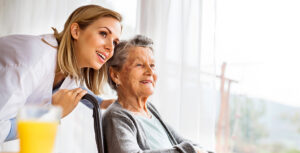 Health visitor and a senior woman during home visit.