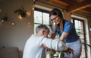 healthcare worker or caregiver visiting senior woman 1200 776