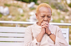 mature woman sitting on outdoor bench 1200 776