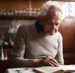 portrait of elderly man sitting at the table indoors 1200 776