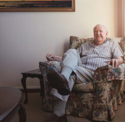 relaxed elderly man sitting on an armchair 1200 776