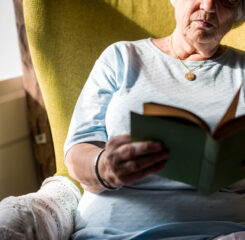senior woman reading a book 1200 776