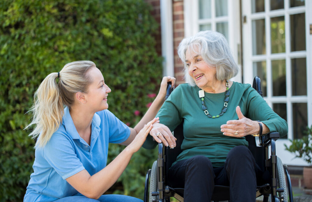 Caregiver assisting resident in wheelchair 1011191318 1200 776