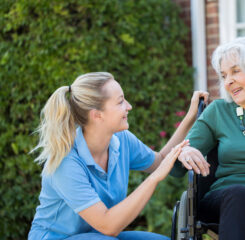 Caregiver assisting resident in wheelchair 1011191318 1200 776