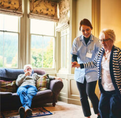 Caregiver assisting resident walking 968995164 1200 776