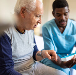 Caregiver helping resident with medicine 1207050363 1200 776