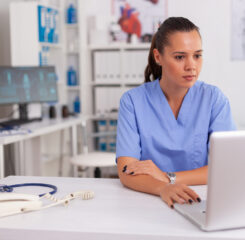 Medical nurse working on laptop